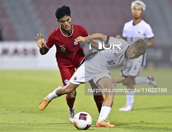 Raoul Suhaimi (L) of Singapore battles for the ball with Chiu Ching Yu Sergio (R) of Hong Kong, China, during the 2025 AFC U20 Asian Cup Qua...