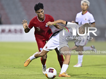 Raoul Suhaimi (L) of Singapore battles for the ball with Chiu Ching Yu Sergio (R) of Hong Kong, China, during the 2025 AFC U20 Asian Cup Qua...