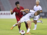 Raoul Suhaimi (L) of Singapore battles for the ball with Chiu Ching Yu Sergio (R) of Hong Kong, China, during the 2025 AFC U20 Asian Cup Qua...