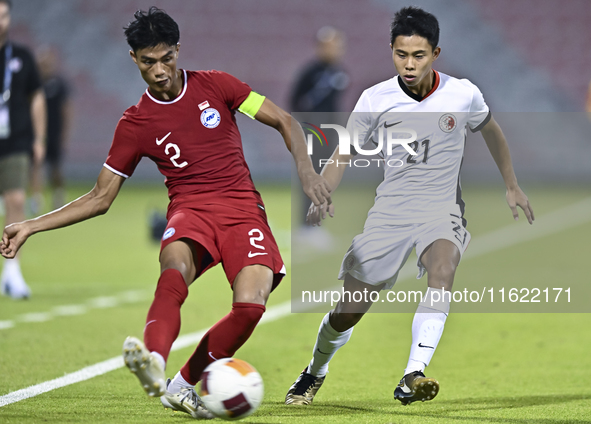 Raoul Suhaimi (L) of Singapore battles for the ball with Lee Chun Ting (R) of Hong Kong, China, during the 2025 AFC U20 Asian Cup Qualifiers...