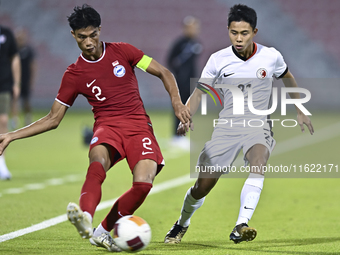 Raoul Suhaimi (L) of Singapore battles for the ball with Lee Chun Ting (R) of Hong Kong, China, during the 2025 AFC U20 Asian Cup Qualifiers...