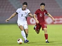 Jonan Tan (R) of Singapore battles for the ball with Matthew Luke Slattery (L) of Hong Kong, China, during the 2025 AFC U20 Asian Cup Qualif...