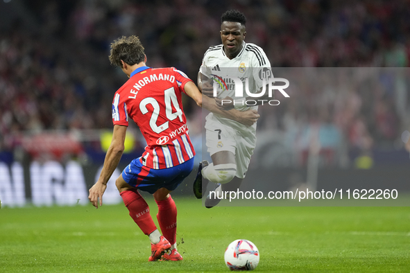 Vinicius Junior left winger of Real Madrid and Brazil and Robin Le Normand centre-back of Atletico de Madrid and Spaincompete for the ball d...