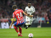 Vinicius Junior left winger of Real Madrid and Brazil and Robin Le Normand centre-back of Atletico de Madrid and Spaincompete for the ball d...