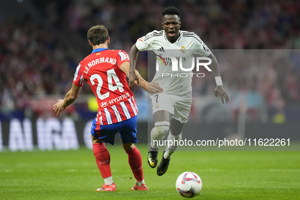 Vinicius Junior left winger of Real Madrid and Brazil and Robin Le Normand centre-back of Atletico de Madrid and Spaincompete for the ball d...