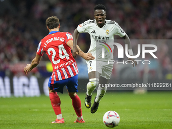 Vinicius Junior left winger of Real Madrid and Brazil and Robin Le Normand centre-back of Atletico de Madrid and Spaincompete for the ball d...