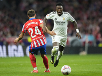 Vinicius Junior left winger of Real Madrid and Brazil and Robin Le Normand centre-back of Atletico de Madrid and Spaincompete for the ball d...