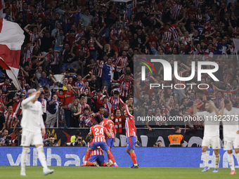 Several players of Atletico de Madrid celebrate a goal during the La Liga 2024/25 match between Atletico de Madrid and Real Madrid at Civita...