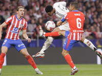 Jude Bellingham of Real Madrid and Koke Resurreccion of Atletico de Madrid fight for the ball during the La Liga 2024/25 match between Atlet...