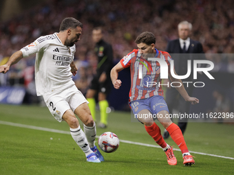 Daniel Carvajal of Real Madrid and Julian Alvarez of Atletico de Madrid fight for the ball during the La Liga 2024/25 match between Atletico...