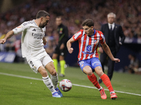 Daniel Carvajal of Real Madrid and Julian Alvarez of Atletico de Madrid fight for the ball during the La Liga 2024/25 match between Atletico...