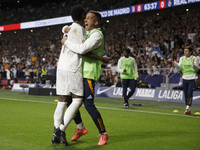 Vinicius Jr. of Real Madrid and Lucas Vazquez of Real Madrid celebrate a goal during the La Liga 2024/25 match between Atletico de Madrid an...