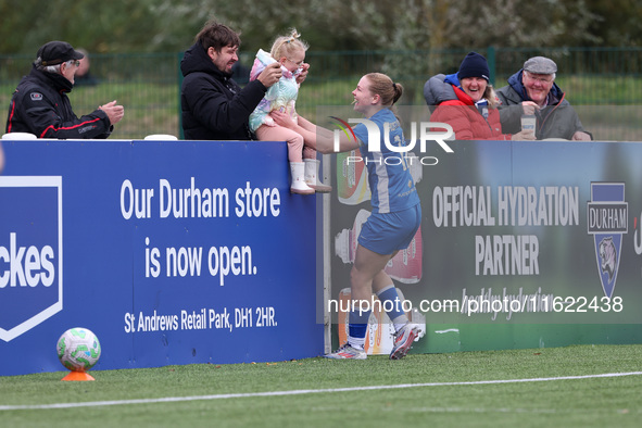 Lily Crosthwaite of Durham Women celebrates with a child spectator after scoring their first goal during the FA Women's Championship match b...