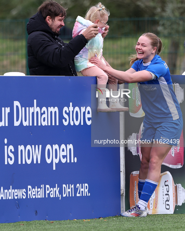 Lily Crosthwaite of Durham Women celebrates with a child spectator after scoring their first goal during the FA Women's Championship match b...