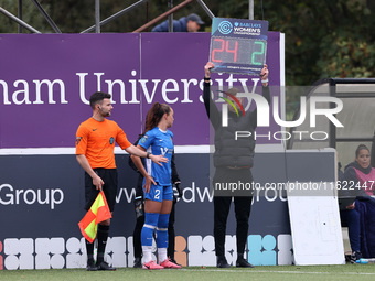 Jon Ashworth-Sears, the fourth official, holds up the Barclays Women Championship branded board to denote a substitution during the FA Women...