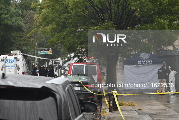 Crime scene investigators use evidence markers to mark the scene where a 29-year-old man is fatally shot in the head at East 182nd Street an...