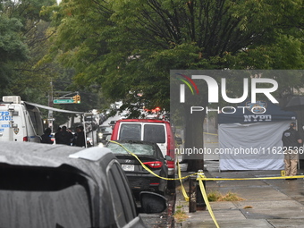 Crime scene investigators use evidence markers to mark the scene where a 29-year-old man is fatally shot in the head at East 182nd Street an...