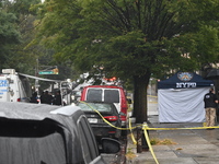 Crime scene investigators use evidence markers to mark the scene where a 29-year-old man is fatally shot in the head at East 182nd Street an...