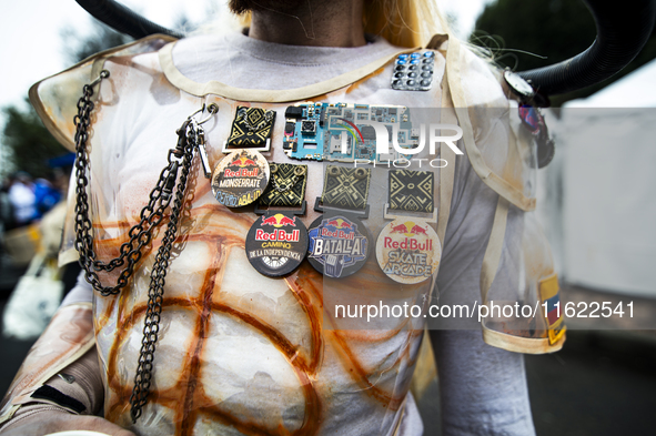 A soapbox racer wears several Red Bull event pins during the Red Bull Balineras race, a soapbox race that returns after 12 years, in Bogota,...