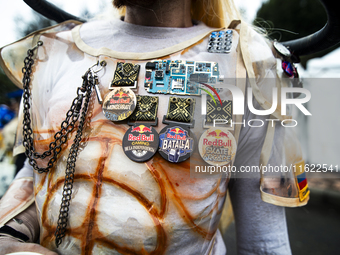 A soapbox racer wears several Red Bull event pins during the Red Bull Balineras race, a soapbox race that returns after 12 years, in Bogota,...