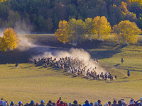 Tourists watch a Ten Thousand Steeds Gallop performance at Ulan Butong Grassland in Chifeng, China, on September 25, 2024. (