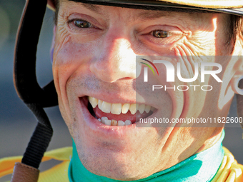 Jockey Justin Stein laughs while celebrating in the winner's circle after riding Roscar to a win in the 134th running of the $400,000 Breede...