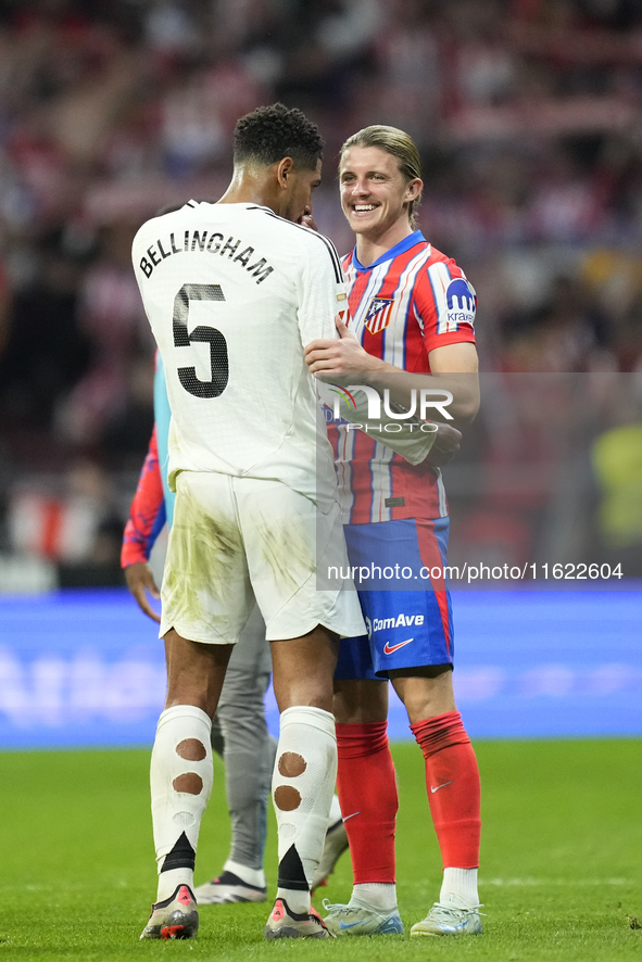 Jude Bellingham central midfield of Real Madrid and England and Conor Gallagher central midfield of Atletico de Madrid and England greets ea...