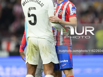 Jude Bellingham central midfield of Real Madrid and England and Conor Gallagher central midfield of Atletico de Madrid and England greets ea...