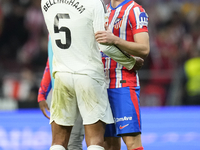 Jude Bellingham central midfield of Real Madrid and England and Conor Gallagher central midfield of Atletico de Madrid and England greets ea...