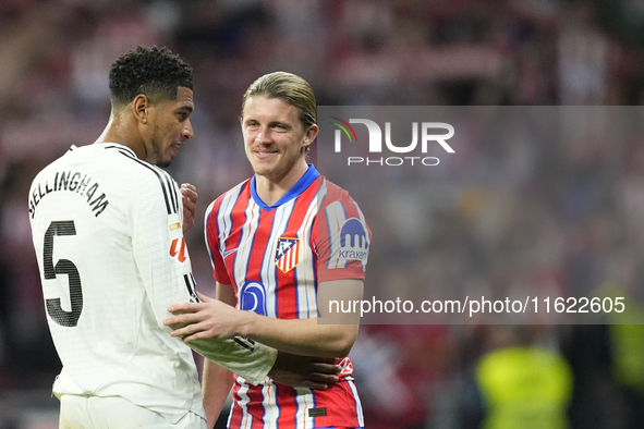 Jude Bellingham central midfield of Real Madrid and England and Conor Gallagher central midfield of Atletico de Madrid and England greets ea...