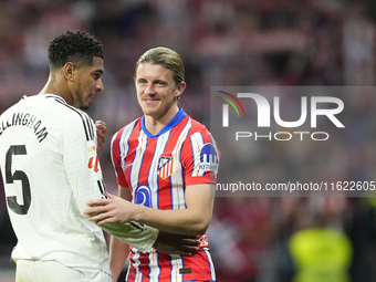 Jude Bellingham central midfield of Real Madrid and England and Conor Gallagher central midfield of Atletico de Madrid and England greets ea...