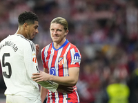 Jude Bellingham central midfield of Real Madrid and England and Conor Gallagher central midfield of Atletico de Madrid and England greets ea...