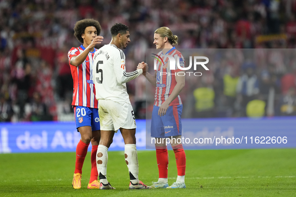 Jude Bellingham central midfield of Real Madrid and England and Conor Gallagher central midfield of Atletico de Madrid and England greets ea...