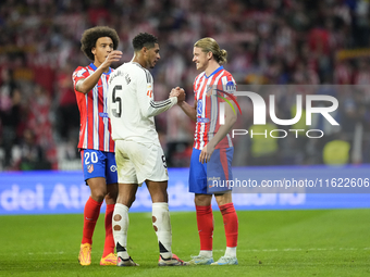 Jude Bellingham central midfield of Real Madrid and England and Conor Gallagher central midfield of Atletico de Madrid and England greets ea...