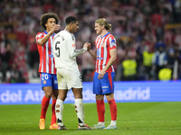 Jude Bellingham central midfield of Real Madrid and England and Conor Gallagher central midfield of Atletico de Madrid and England greets ea...