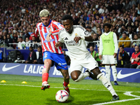 Vinicius Junior left winger of Real Madrid and Brazil and Rodrigo de Paul central midfield of Atletico de Madrid and Argentina compete for t...