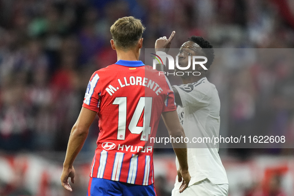 Vinicius Junior left winger of Real Madrid and Brazil and   Marcos Llorente central midfield of Atletico de Madrid and Spain argues during t...