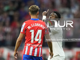 Vinicius Junior left winger of Real Madrid and Brazil and   Marcos Llorente central midfield of Atletico de Madrid and Spain argues during t...