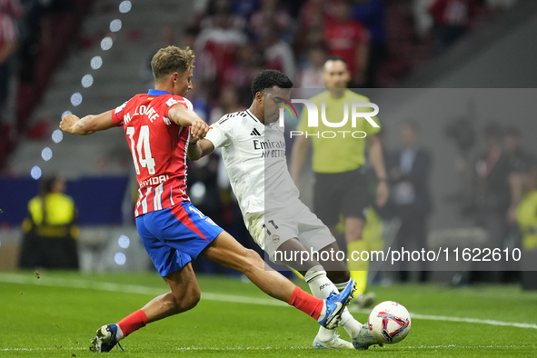 Rodrygo Goes right winger of Real Madrid and Brazil and Marcos Llorente central midfield of Atletico de Madrid and Spain compete for the bal...