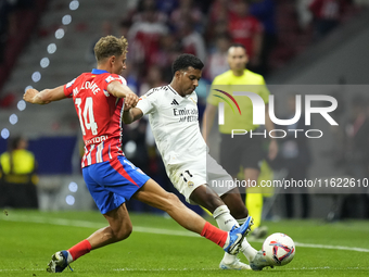 Rodrygo Goes right winger of Real Madrid and Brazil and Marcos Llorente central midfield of Atletico de Madrid and Spain compete for the bal...