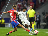 Rodrygo Goes right winger of Real Madrid and Brazil and Marcos Llorente central midfield of Atletico de Madrid and Spain compete for the bal...