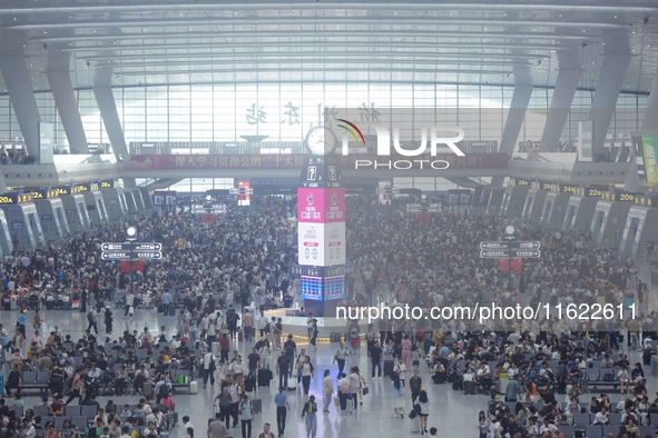 Passengers wait at the waiting hall of Hangzhou East Railway Station in Hangzhou, China, on September 30, 2024. On the day before the Nation...