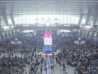 Passengers wait at the waiting hall of Hangzhou East Railway Station in Hangzhou, China, on September 30, 2024. On the day before the Nation...