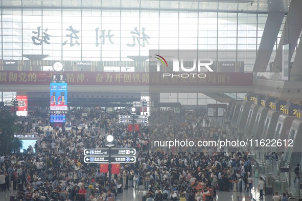 Passengers wait at the waiting hall of Hangzhou East Railway Station in Hangzhou, China, on September 30, 2024. On the day before the Nation...