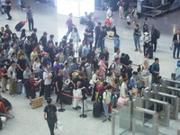 Passengers wait at the waiting hall of Hangzhou East Railway Station in Hangzhou, China, on September 30, 2024. On the day before the Nation...