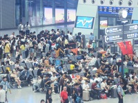 Passengers wait at the waiting hall of Hangzhou East Railway Station in Hangzhou, China, on September 30, 2024. On the day before the Nation...