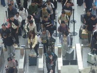 Passengers wait at the waiting hall of Hangzhou East Railway Station in Hangzhou, China, on September 30, 2024. On the day before the Nation...