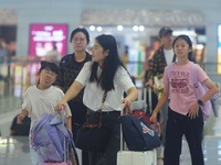 Passengers wait at the waiting hall of Hangzhou East Railway Station in Hangzhou, China, on September 30, 2024. On the day before the Nation...