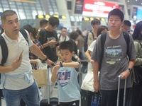 Passengers wait at the waiting hall of Hangzhou East Railway Station in Hangzhou, China, on September 30, 2024. On the day before the Nation...