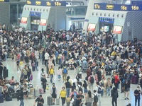 Passengers wait at the waiting hall of Hangzhou East Railway Station in Hangzhou, China, on September 30, 2024. On the day before the Nation...